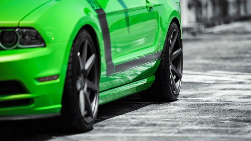 green sports car on asphalt