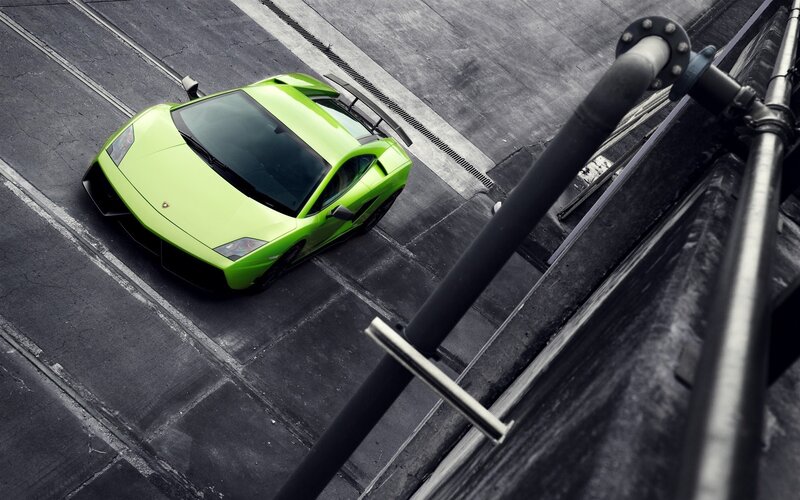 green sports car on concrete