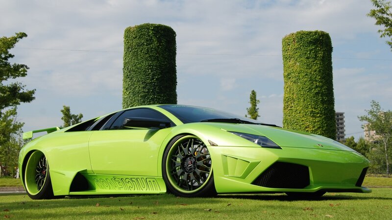green sports car on grass