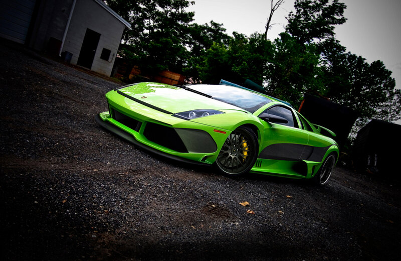 green sports car on gravel