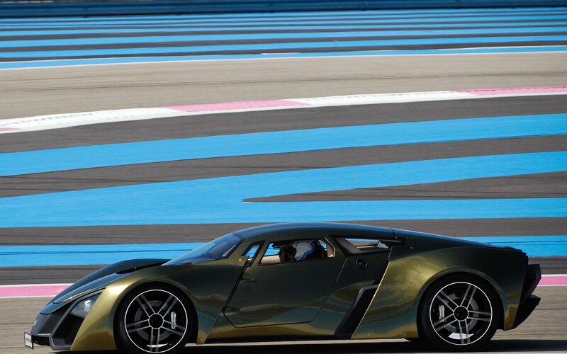 green sports car on racetrack