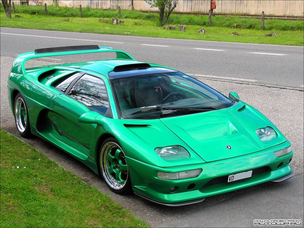 green sports car on roadside