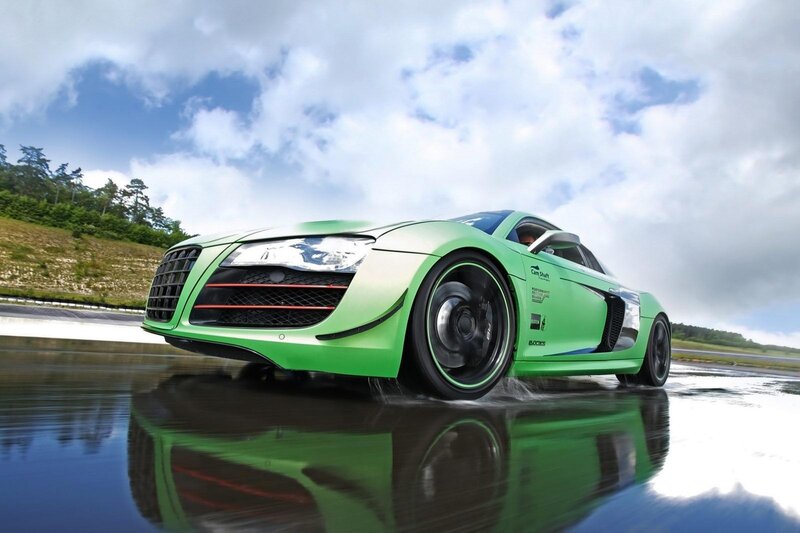 Green sports car on wet track