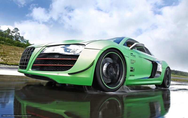 green sports car on wet track