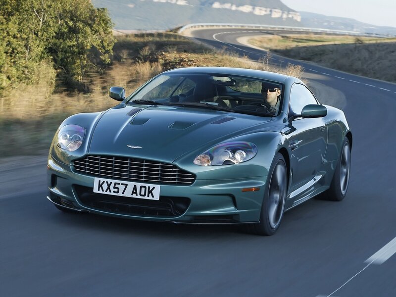 green sports car on winding road