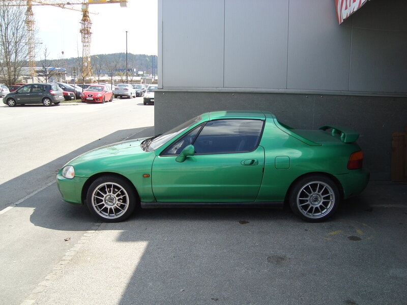 green sports car parked outside