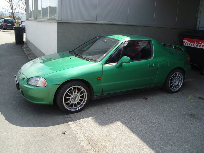 green sports car parked outside