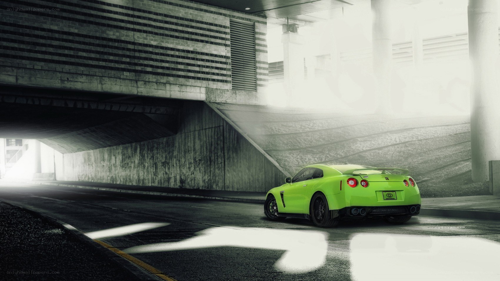 green sports car under overpass