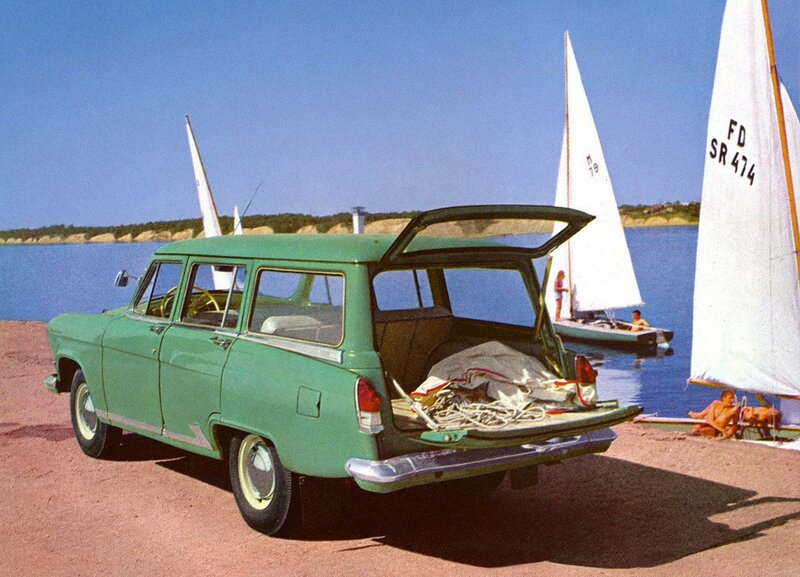 Green station wagon by the lake
