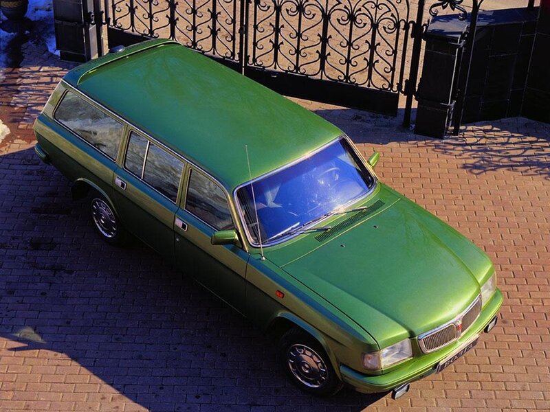 green station wagon on brick pavement