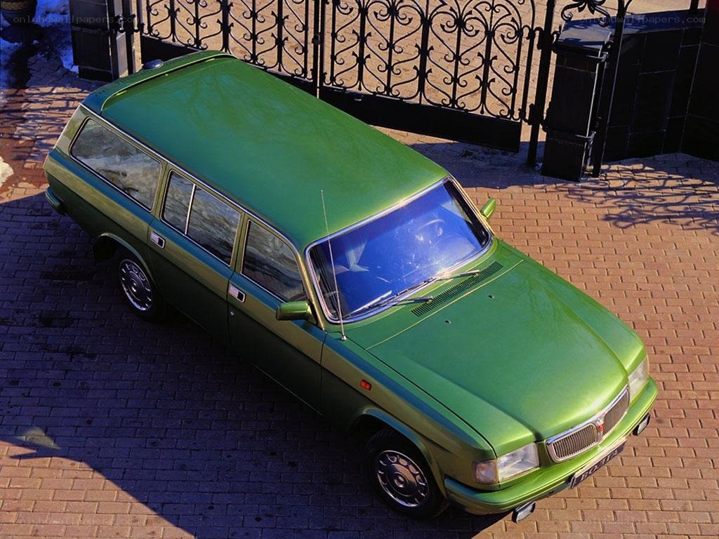 green station wagon on brick pavement