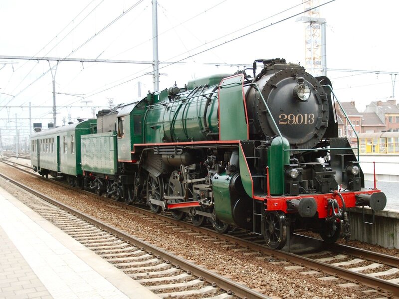 green steam locomotive at station