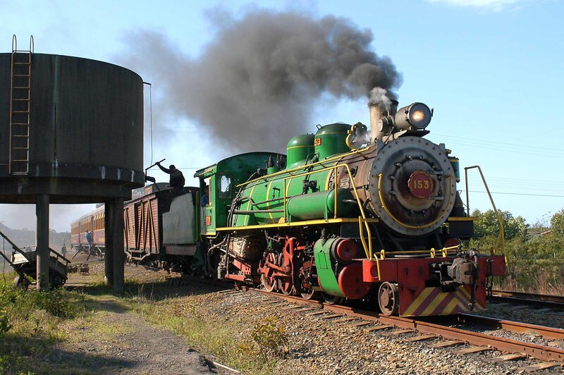 Green steam locomotive at station