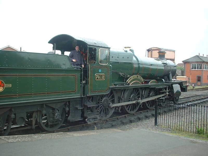 Green steam locomotive on tracks