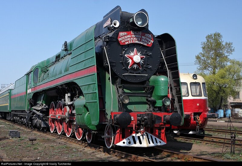 Green steam locomotive on tracks