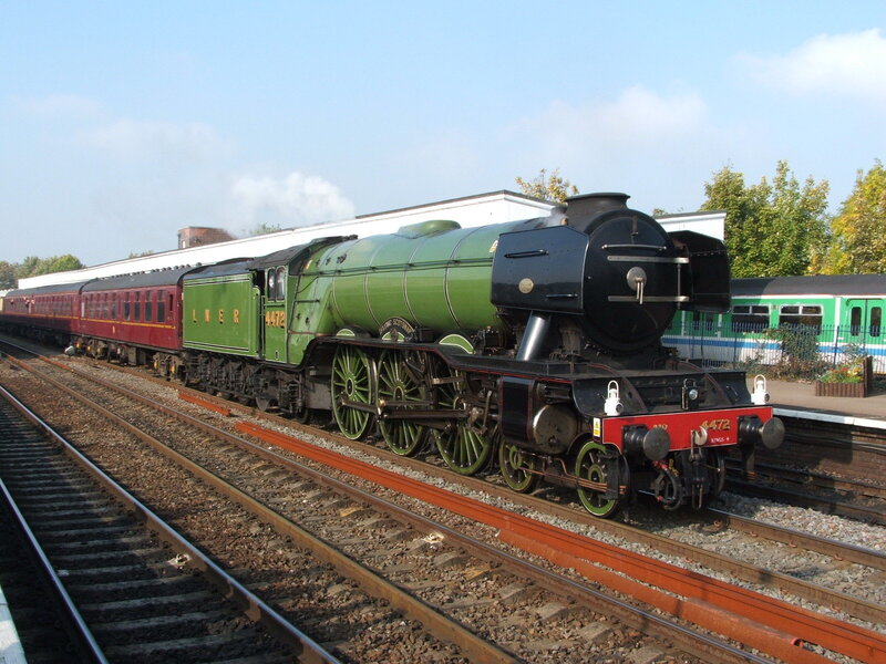 Green steam locomotive on tracks