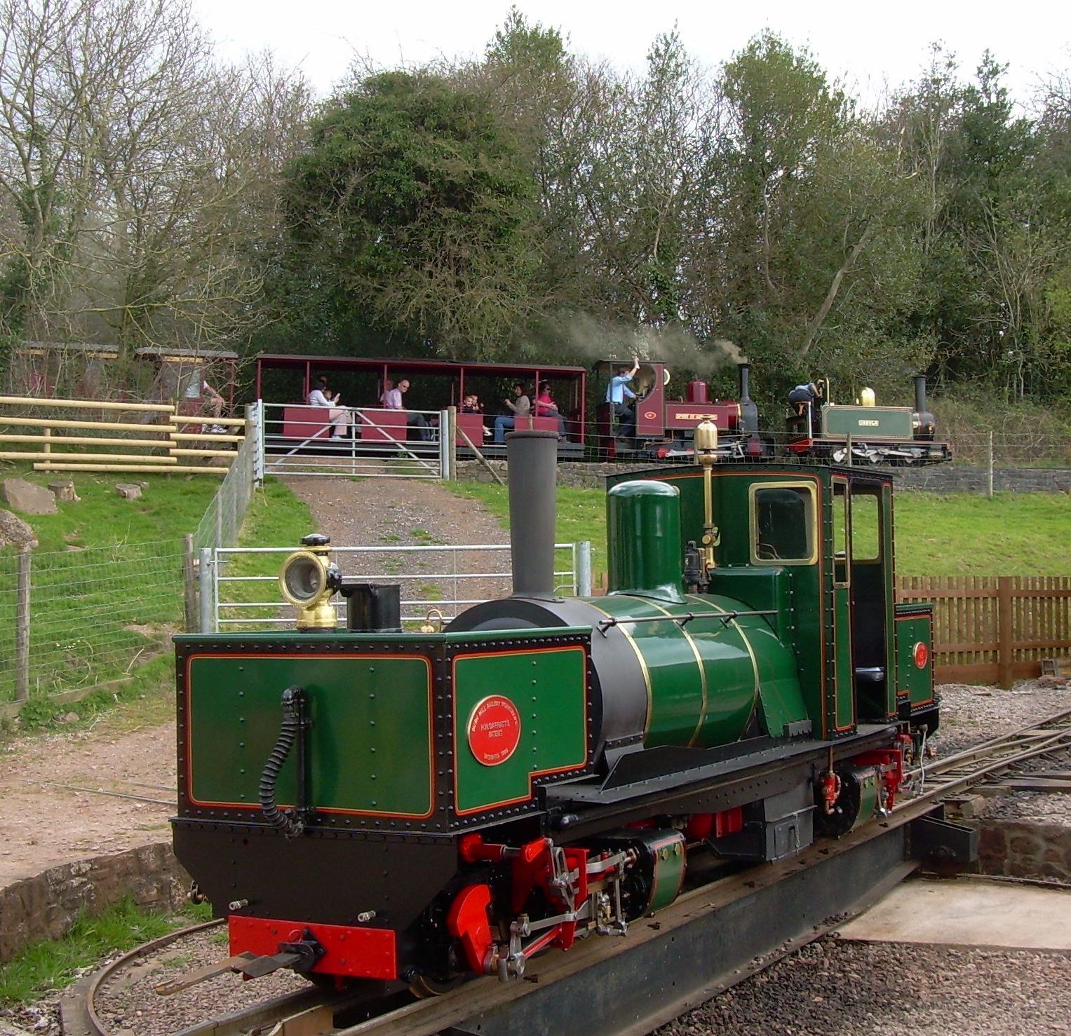 green steam train at a park