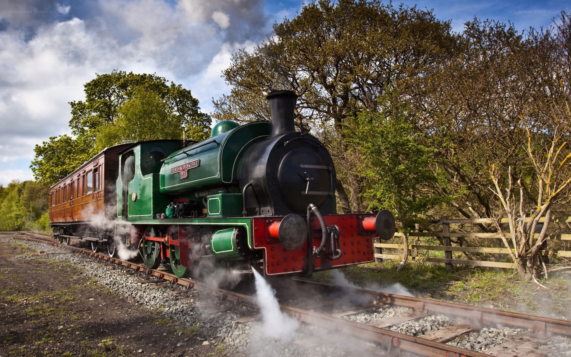 green steam train on tracks
