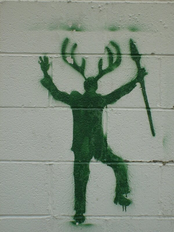green stencil of antlered figure