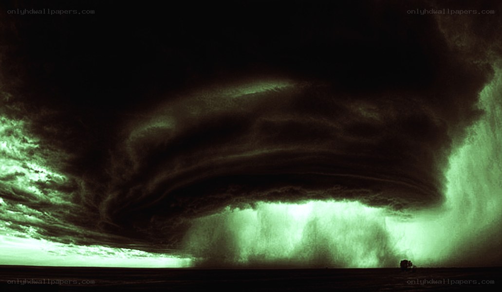 Green storm cloud over field