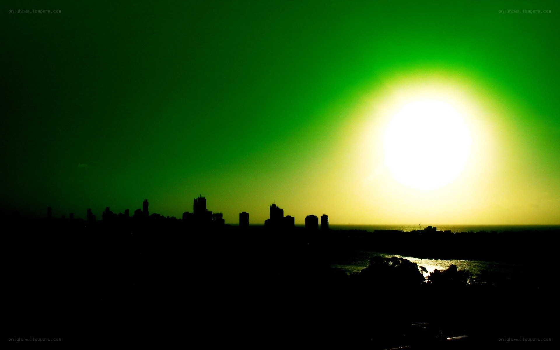 green sunset over city skyline