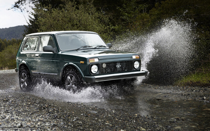 green suv crossing stream