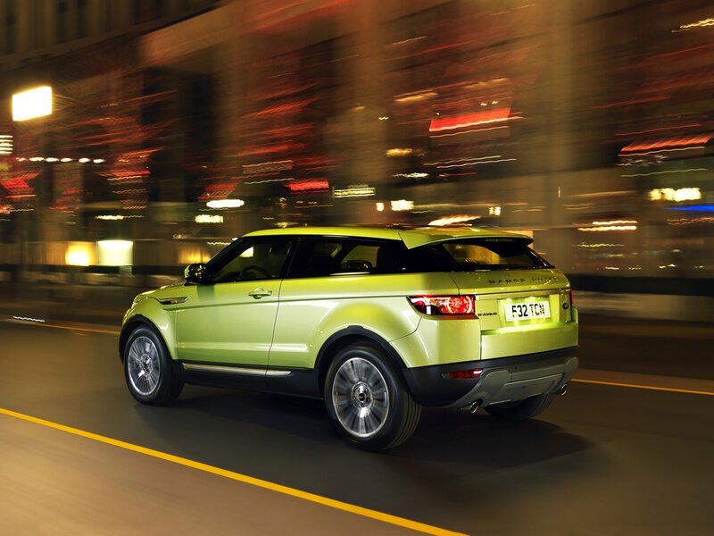 Green SUV driving at night