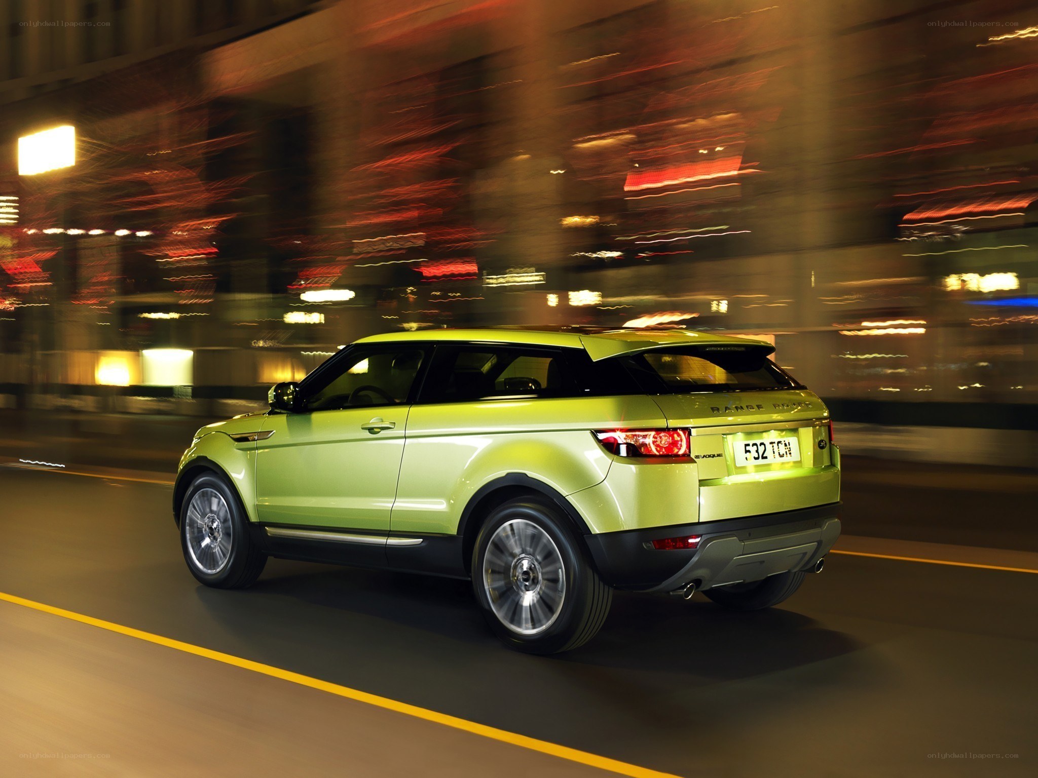 Green SUV driving at night