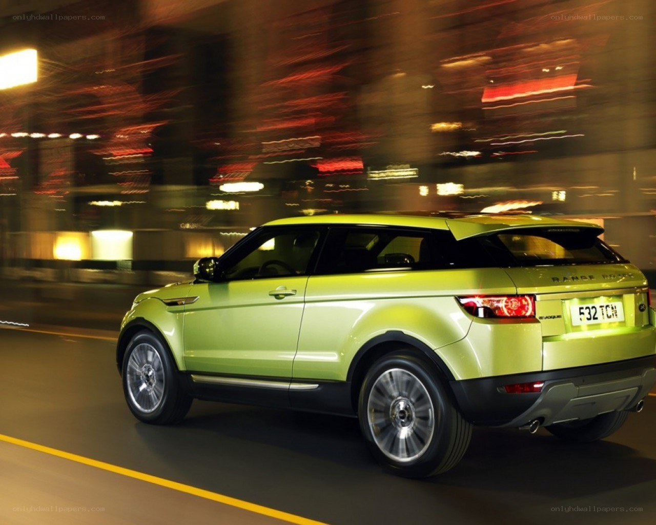 Green SUV in motion at night