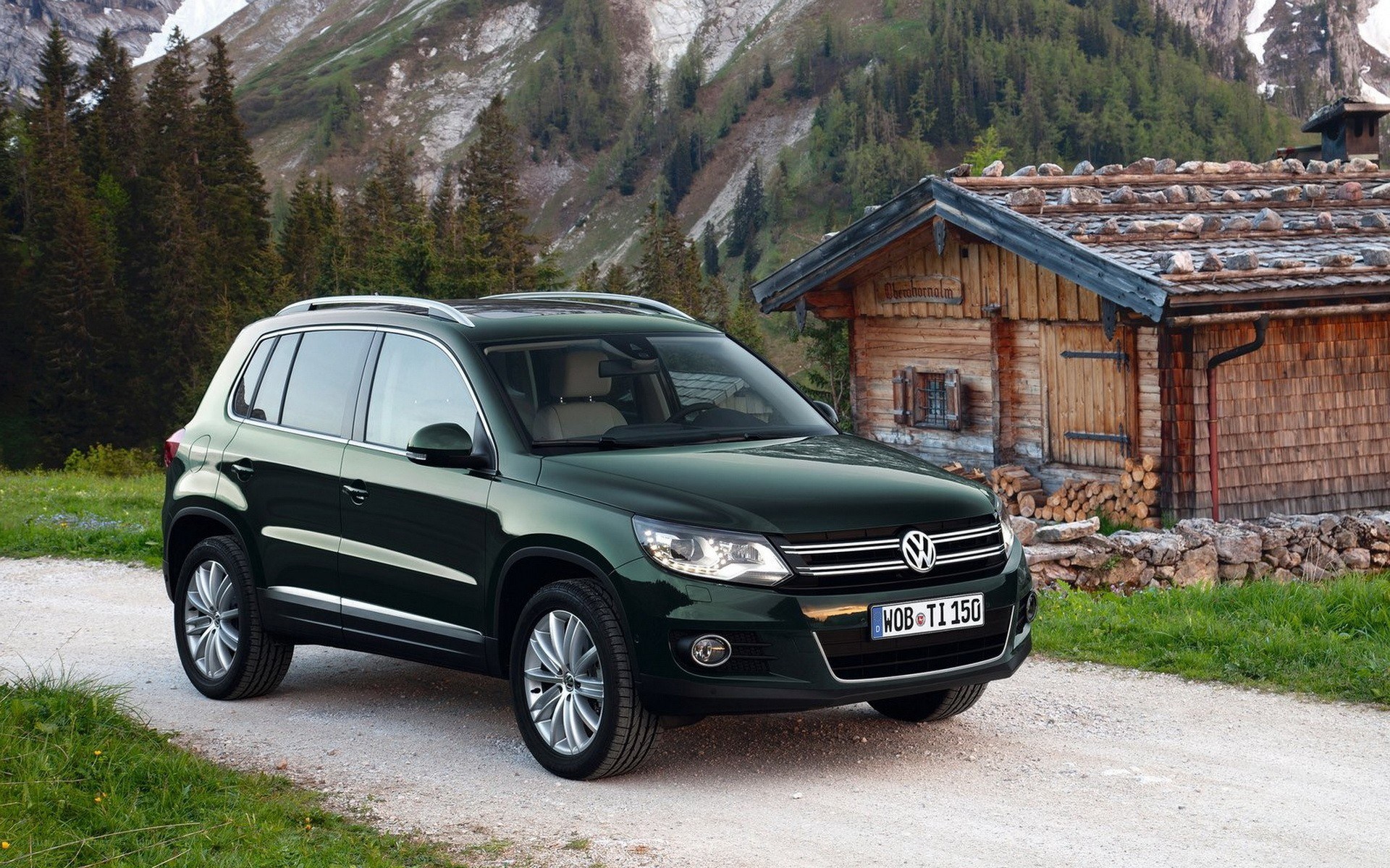 Green SUV in mountain setting