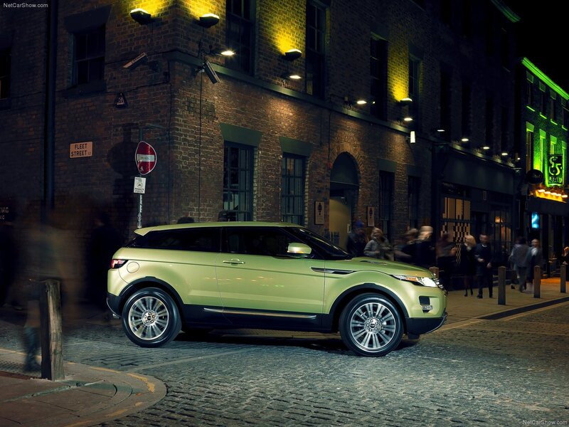 Green SUV on cobblestone street