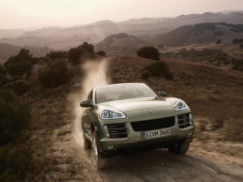 Green SUV on Dirt Road