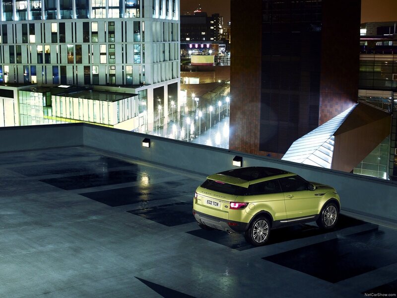 Green SUV on rooftop at night