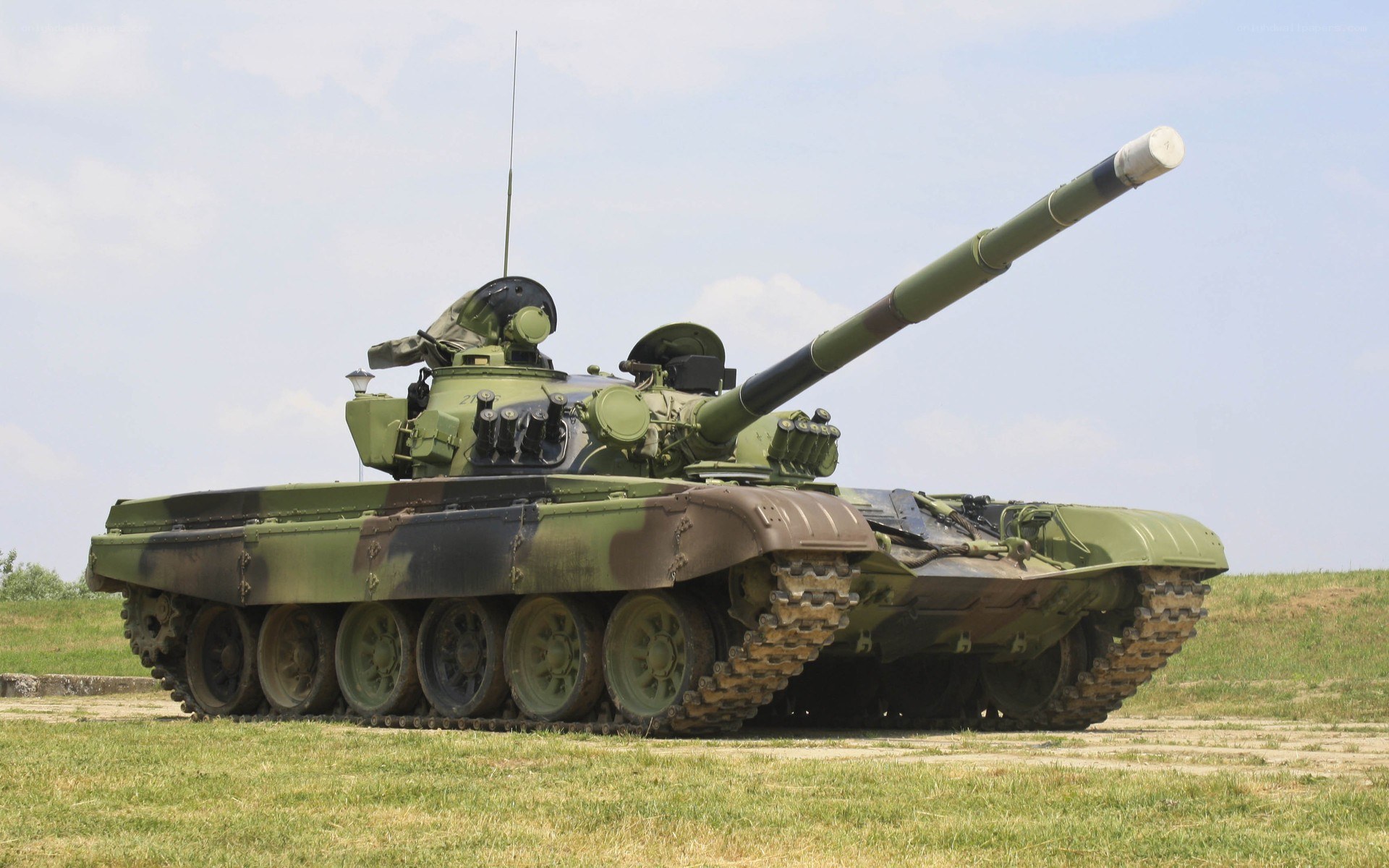 Green tank on grass field