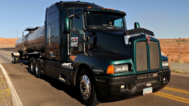 green tanker truck on highway