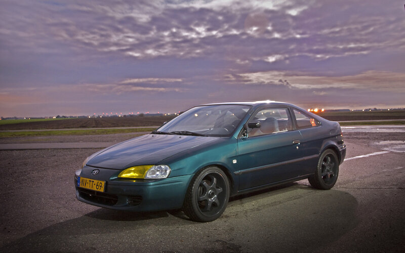 green toyota car at dusk