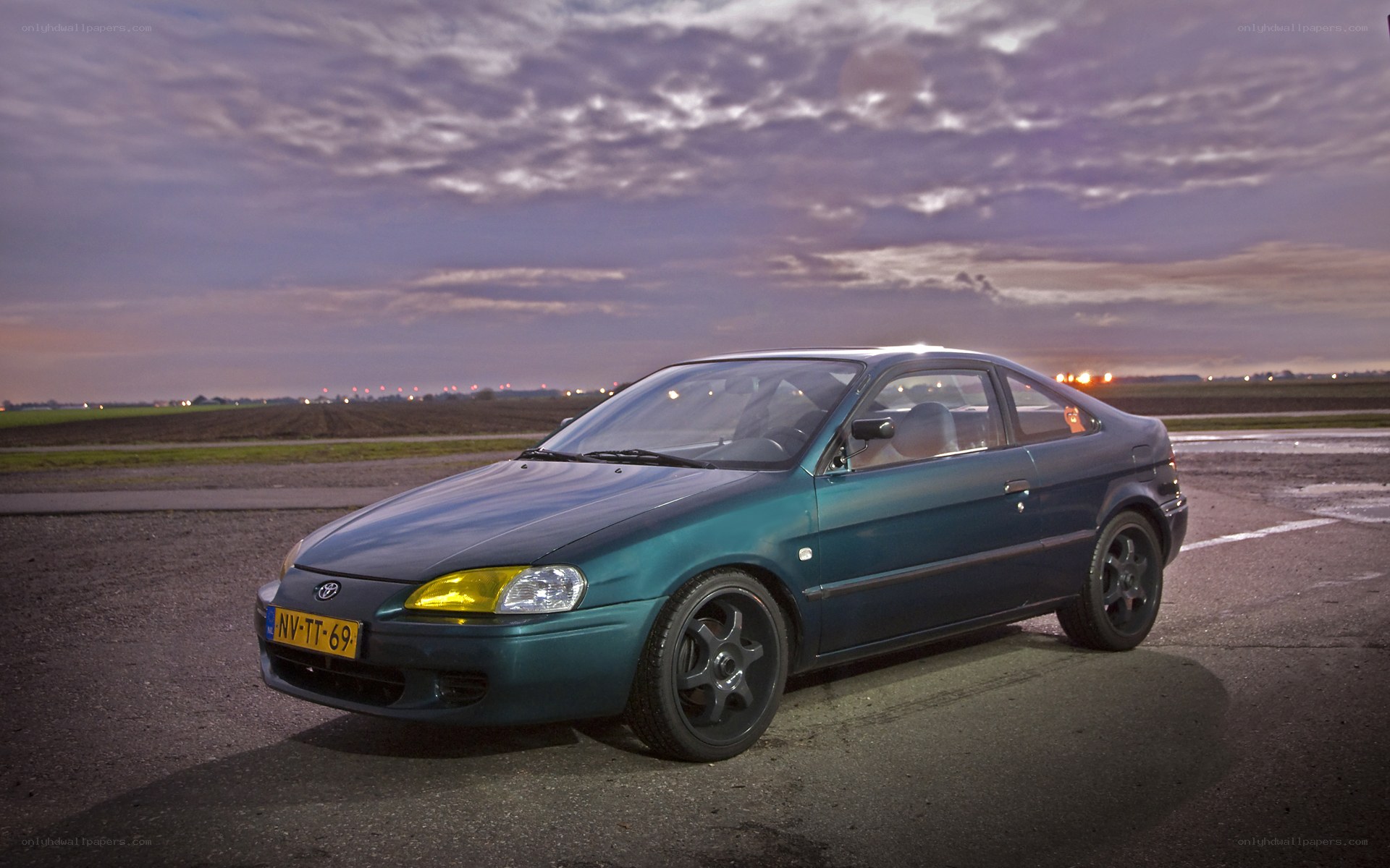 green toyota car at dusk