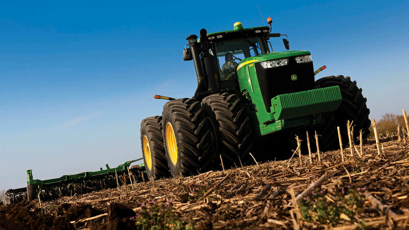Green Tractor in Field — Dramatic, Afternoon, Photograph