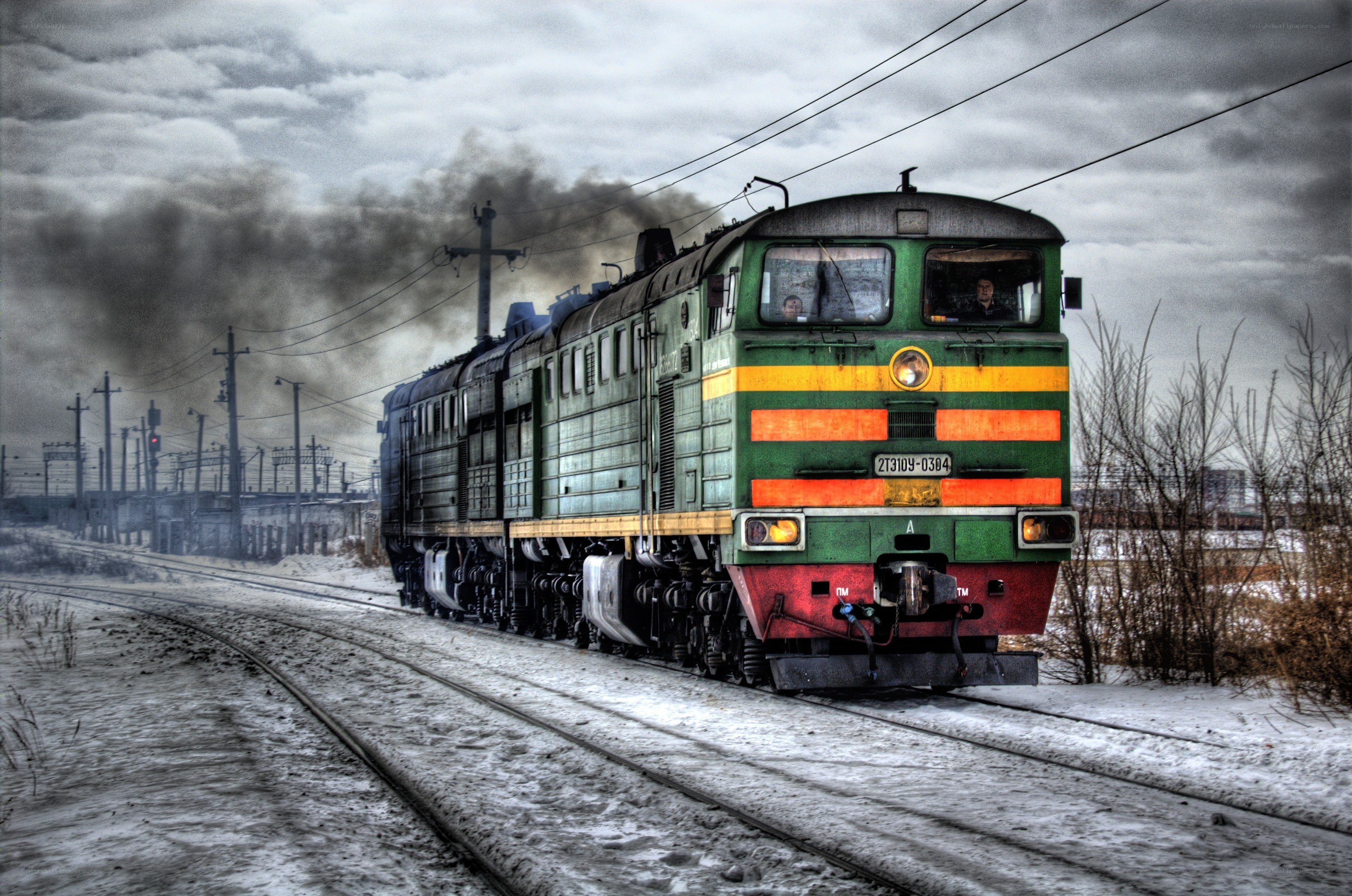Green train in snowy landscape