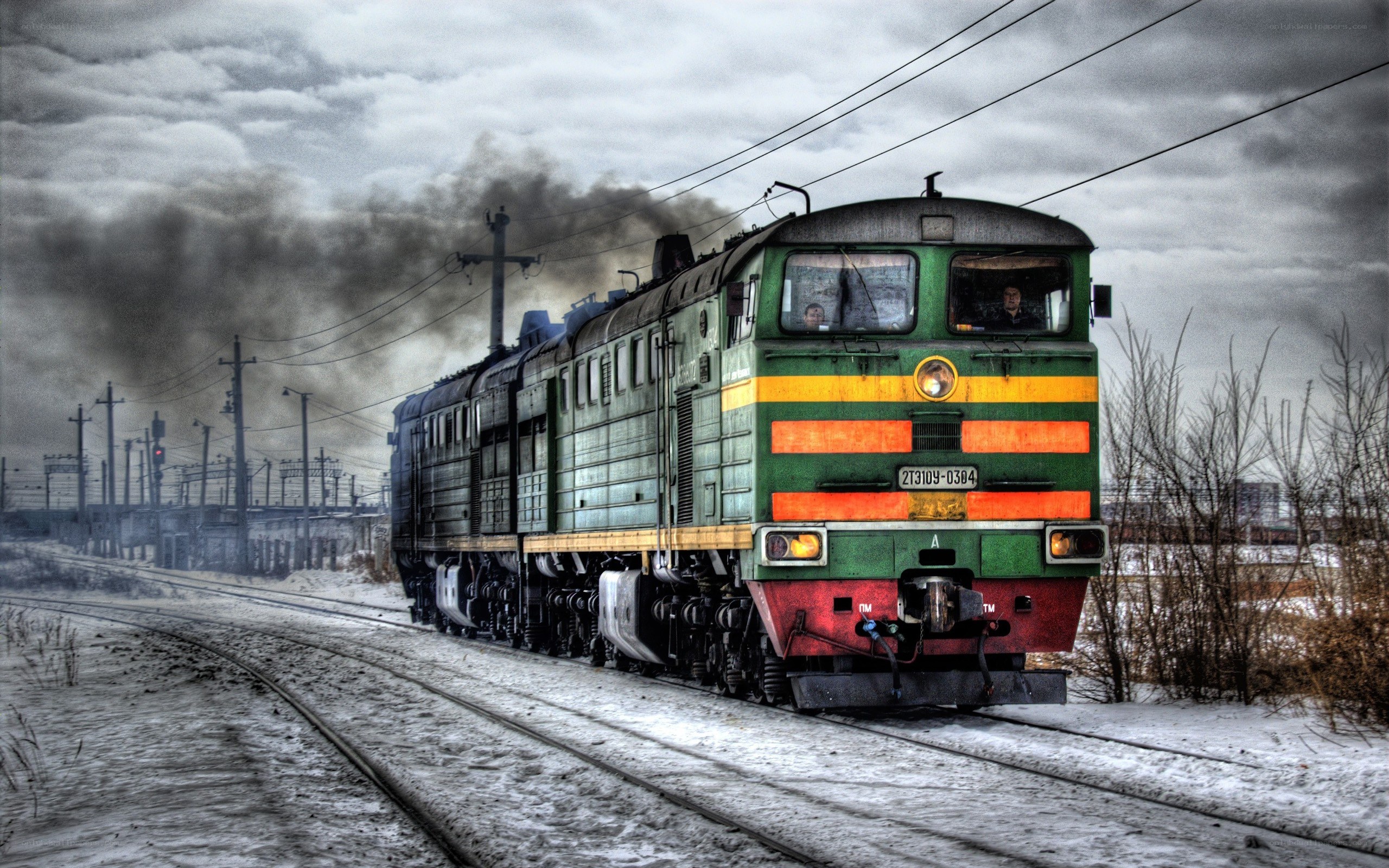 Green train in snowy landscape