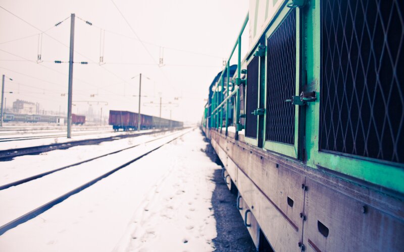 Green train in snowy rail yard