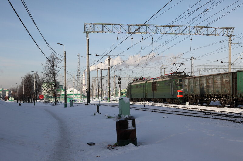 Green train in snowy railway yard