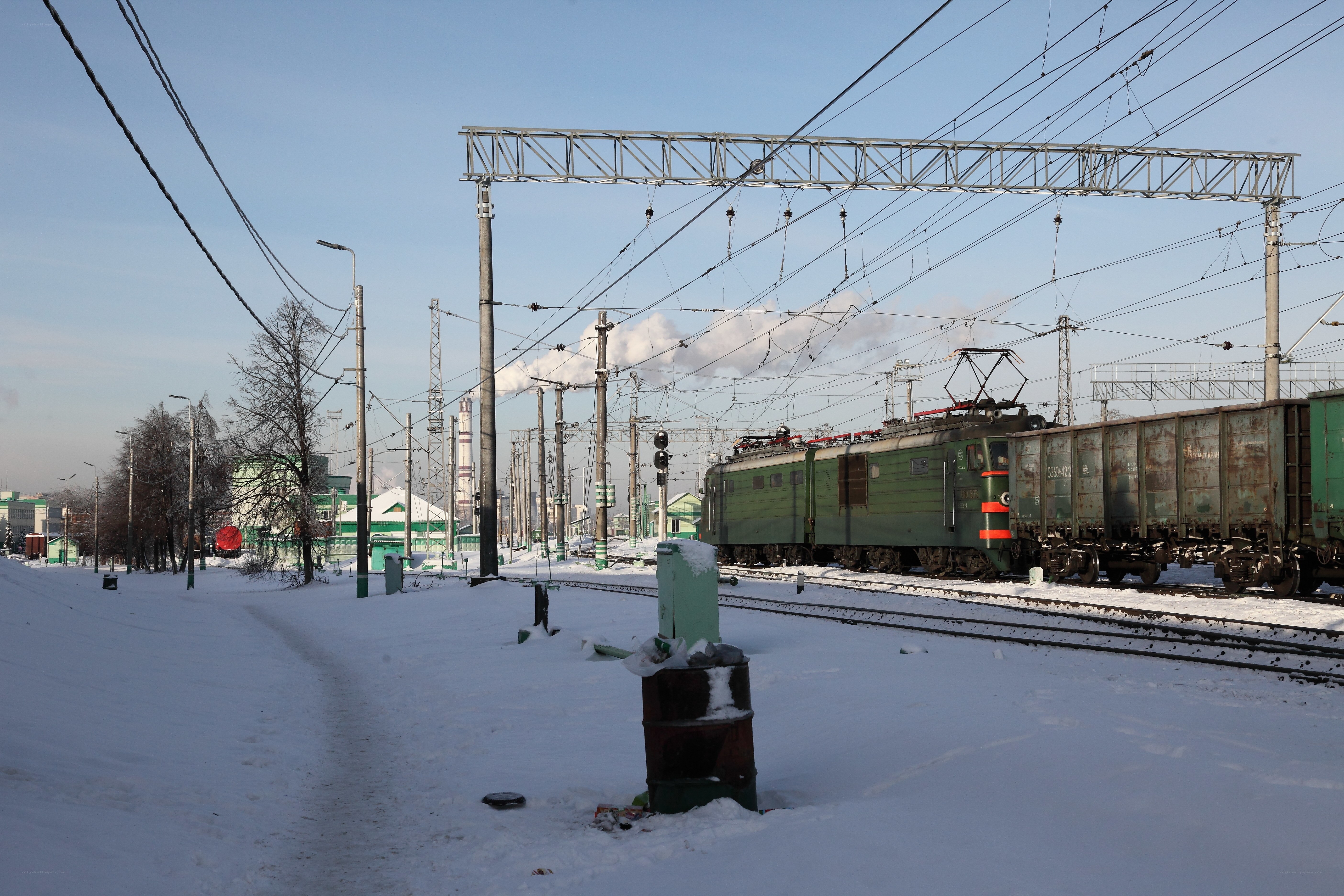 Green train in snowy railway yard