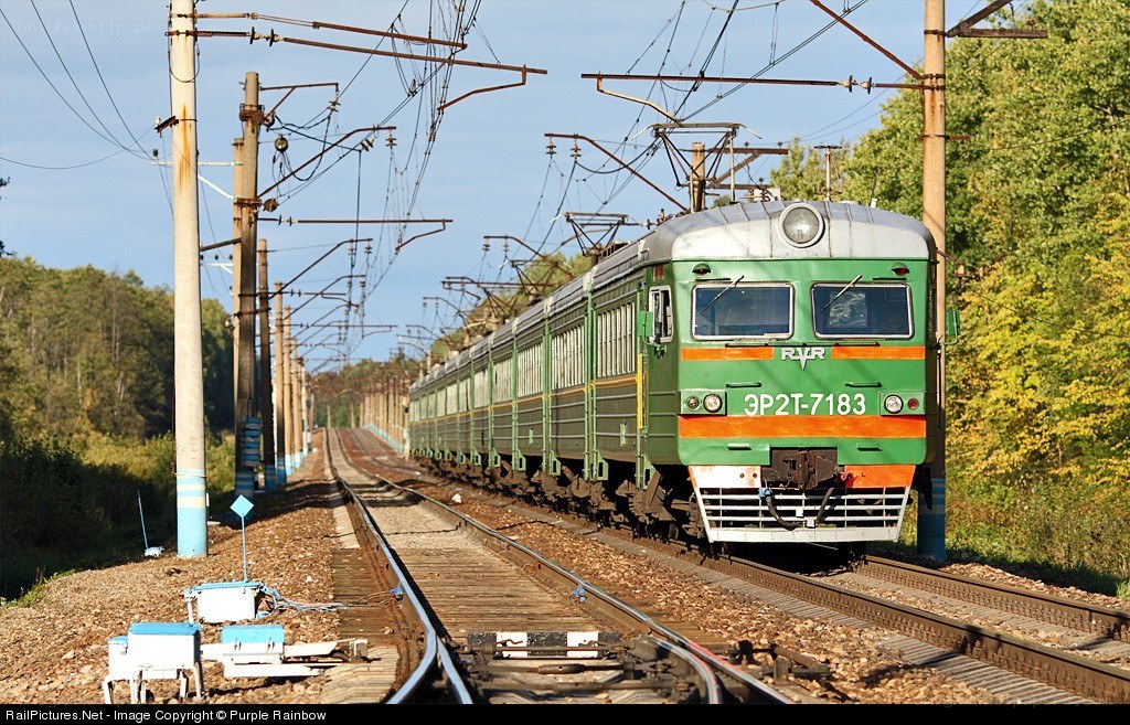 Green train on railway tracks