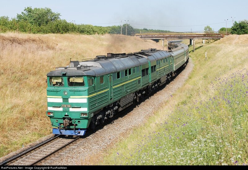 Green train on rural track