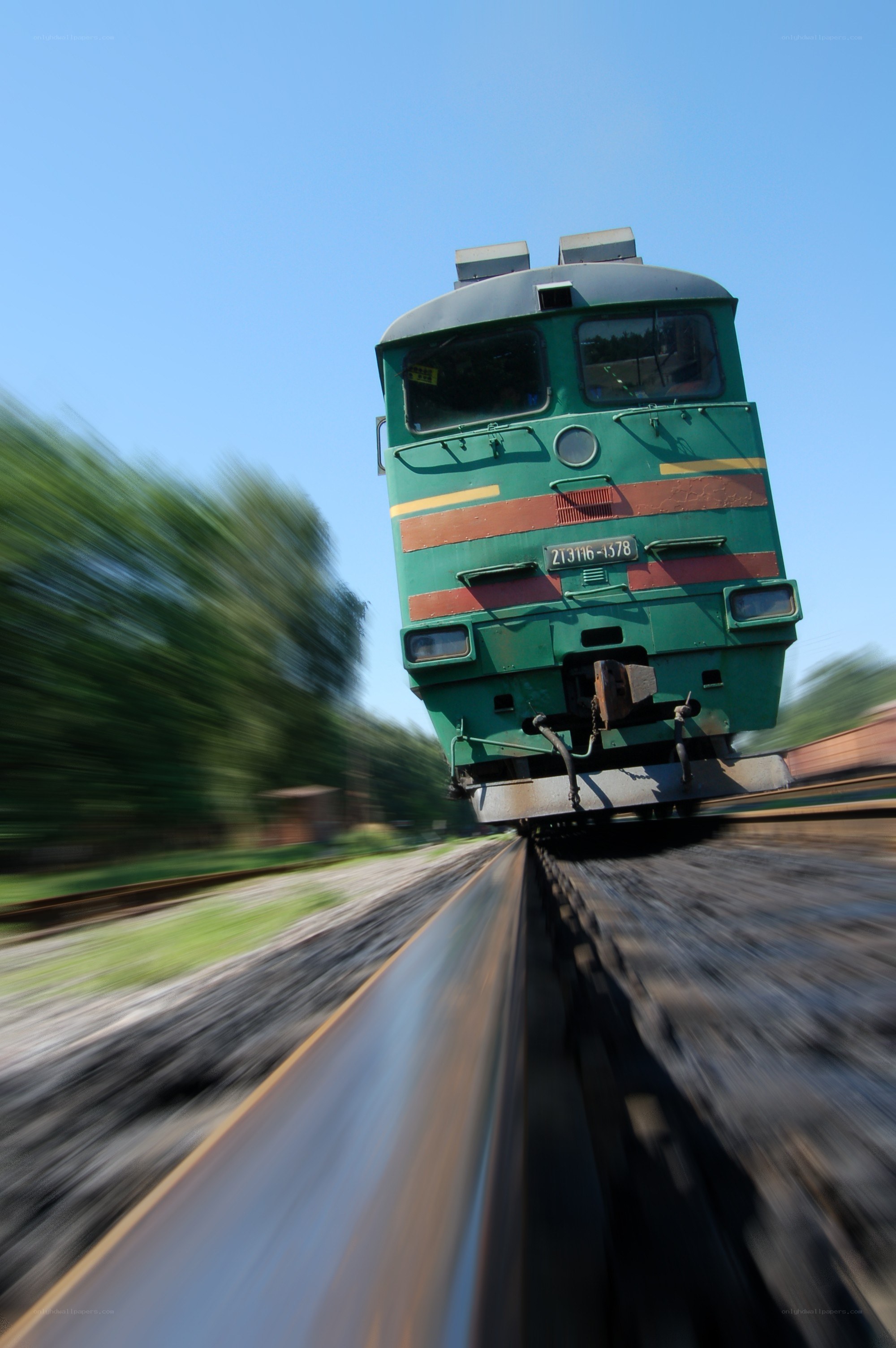 Green train speeding on tracks