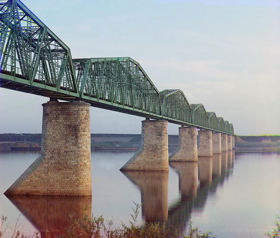 Green truss bridge over river