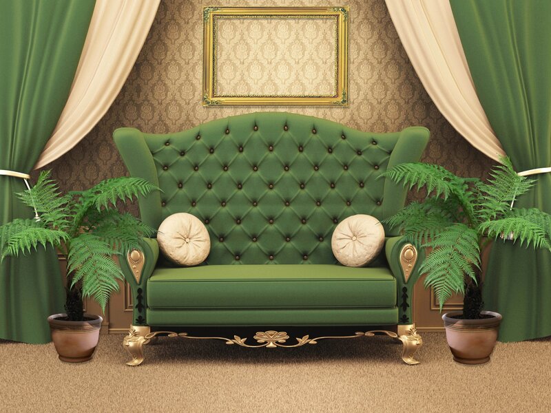 Green tufted sofa with plants