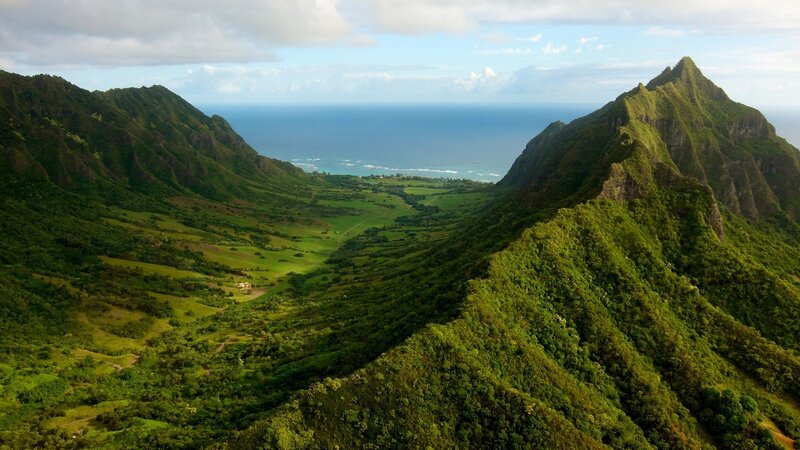 green valley between mountains