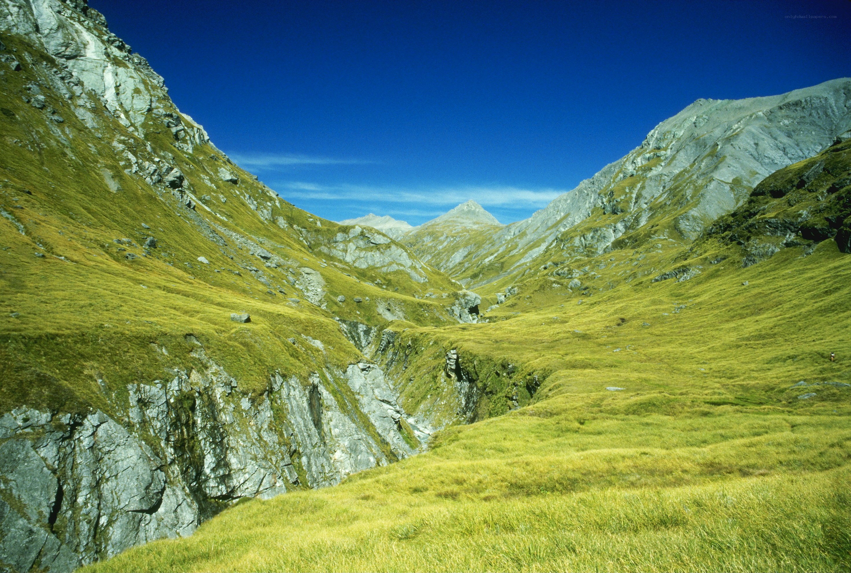 Green valley between rocky mountains